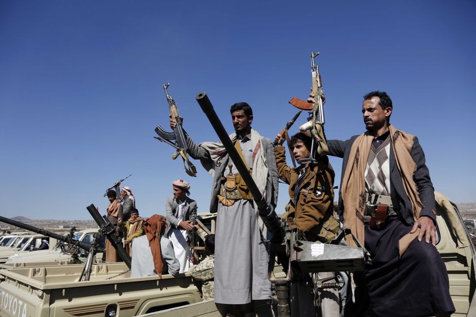 Members of different tribes shout anti-US slogans with guns in hands as they stage a protest against United States' attacks on Yemen's Houthis near Sanaa, Yemen