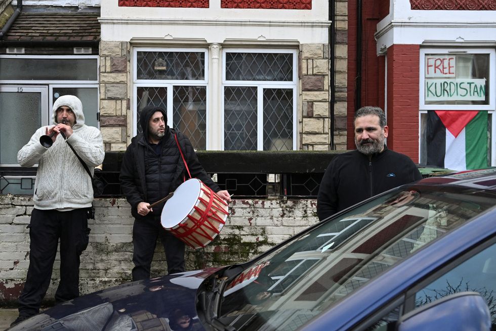 Members of the Kurdish community play music near a Kurdish community centre