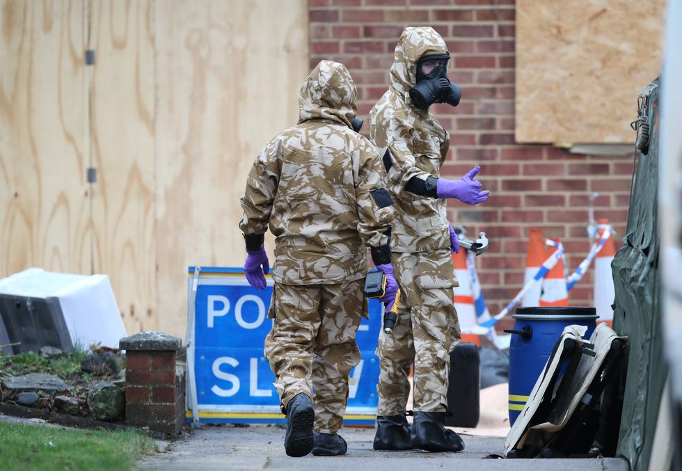 Members of the military wear protective clothing as work continues on the home of former Russian spy Sergei Skripal in Salisbury