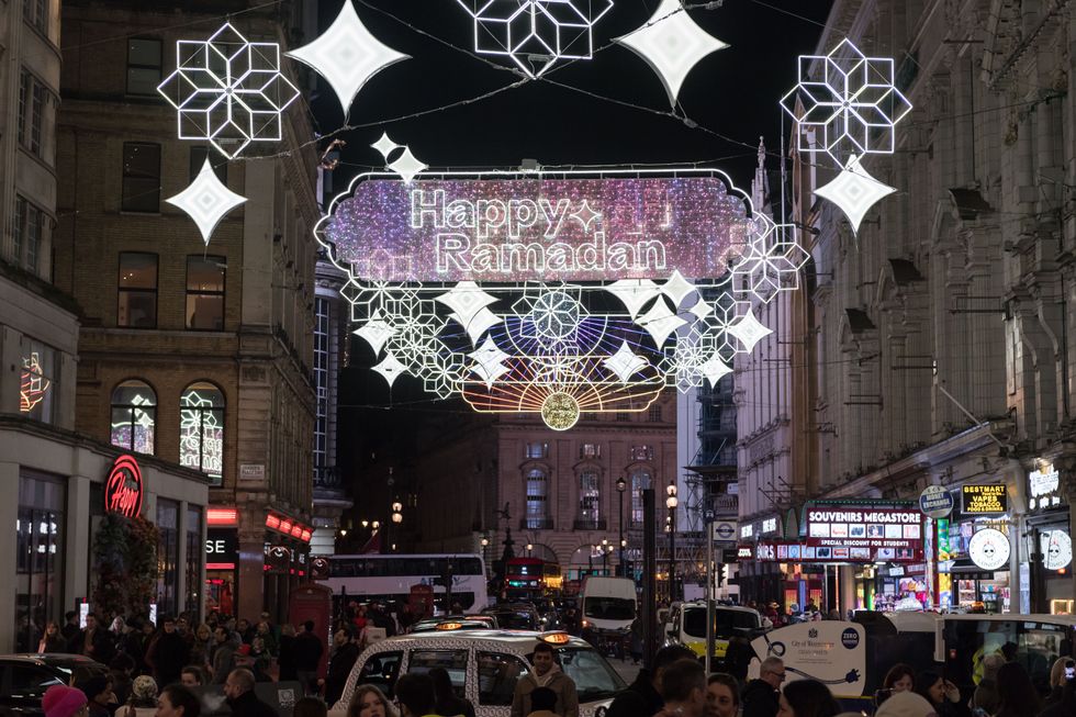 Members of the public gather to watch Ramadan lights installation at Piccadilly Circus