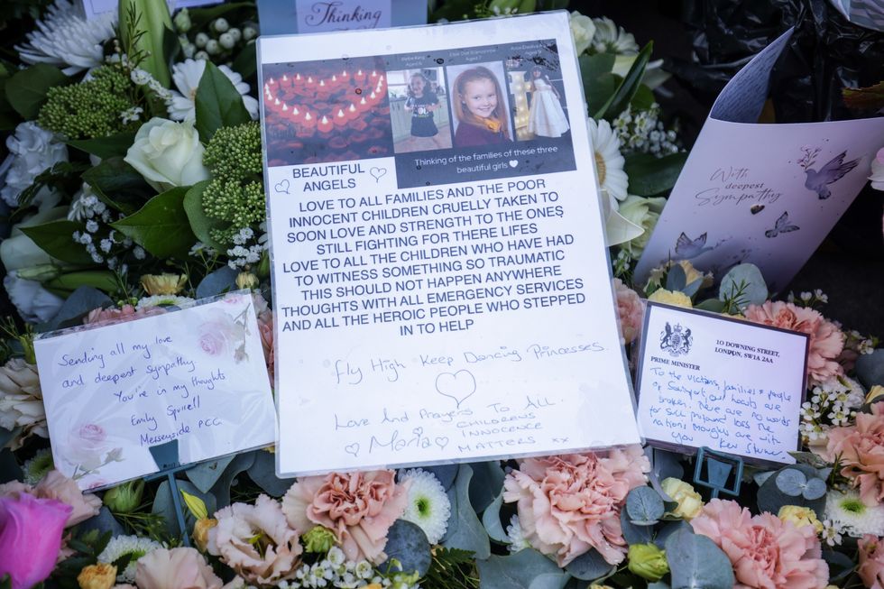 Messages and floral tributes on the junction of Tithebarn Road and Hart Street in Southport