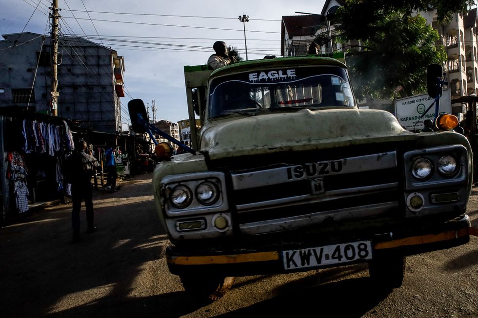 Motorists drive past the busy traffic caused by the presidential escort motorcade after Kenya's President Dr. William Ruto's visit in Kibera Slum