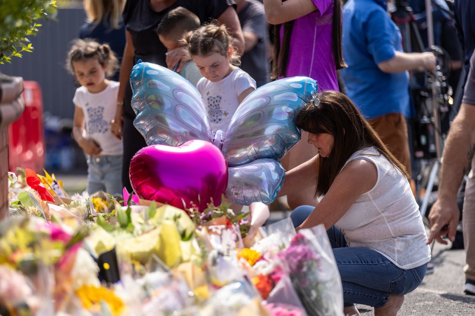 Mourners laying balloons