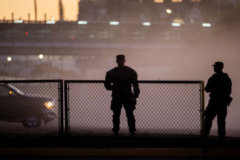 : National Guard soldiers stand guard on the banks of the Rio Grande river at Shelby Park on January 12, 2024 in Eagle Pass, Texas.