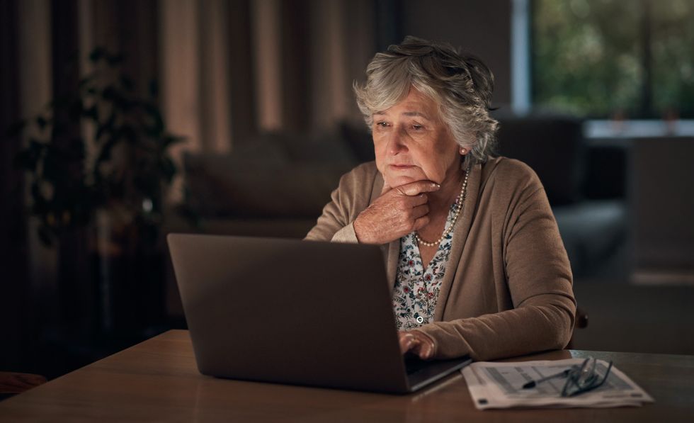 Old woman looking at laptop