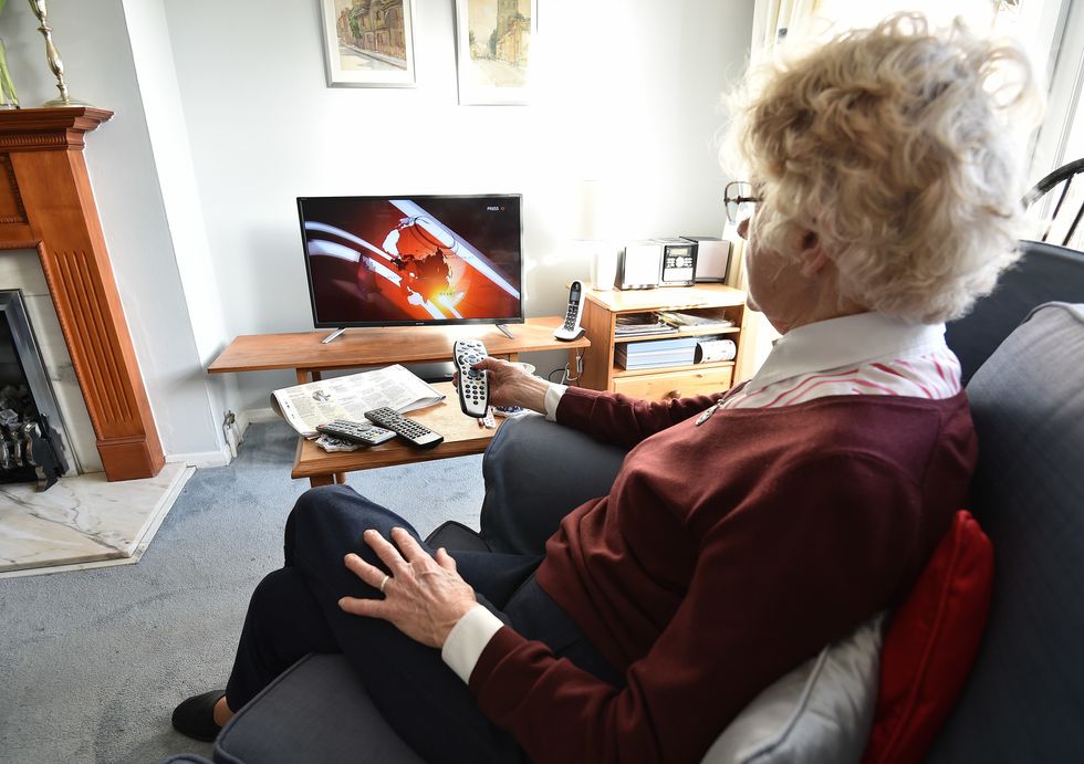 Older woman watching BBC on TV