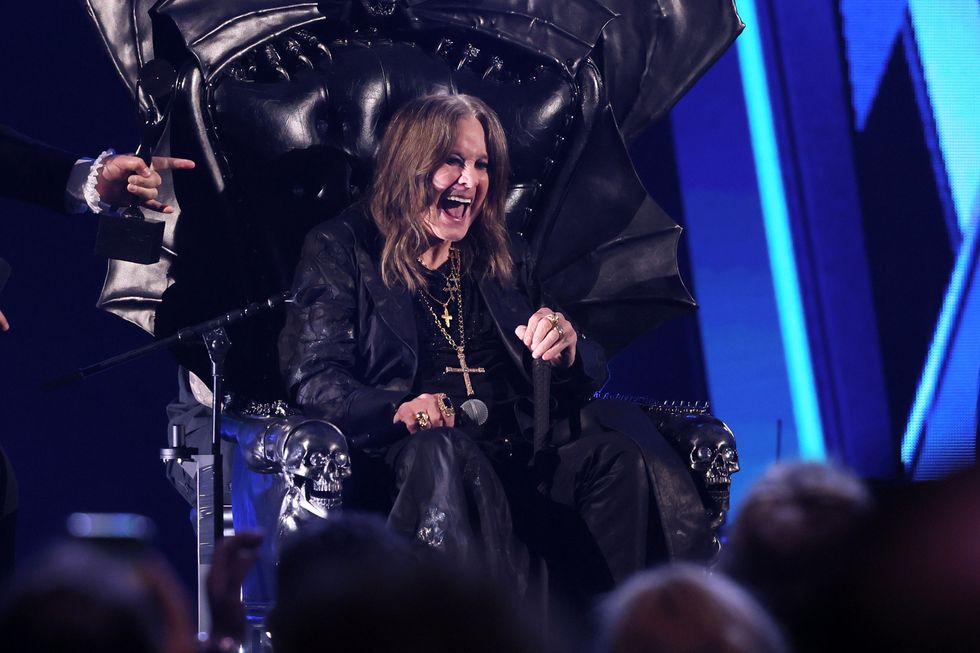 Ozzy Osbourne sits on a throne on stage