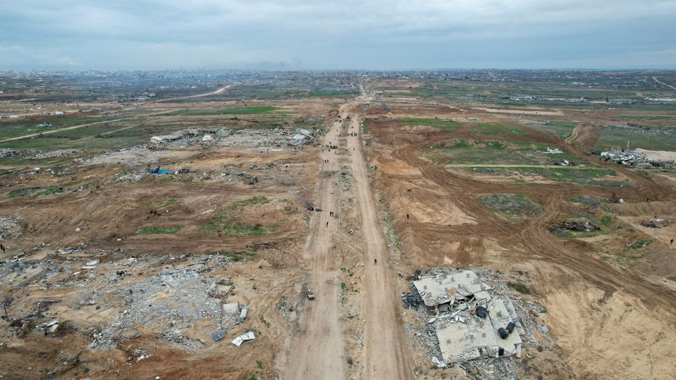 Palestinians making their way past the rubble after Israeli forces withdrew from the Netzarim Corridor, amid a ceasefire between Israel and Hamas, near Gaza City