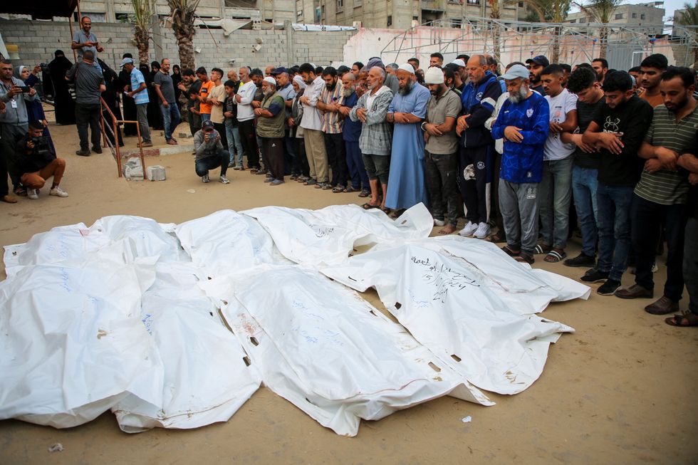 Palestinians mourn people killed in Israeli air strikes in Gaza