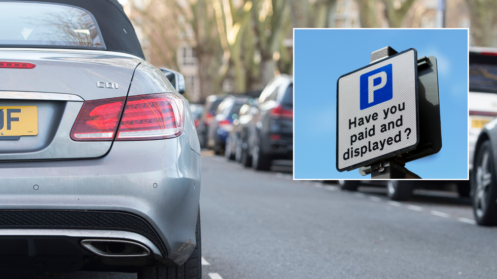 Parked cars and a pay and display parking sign