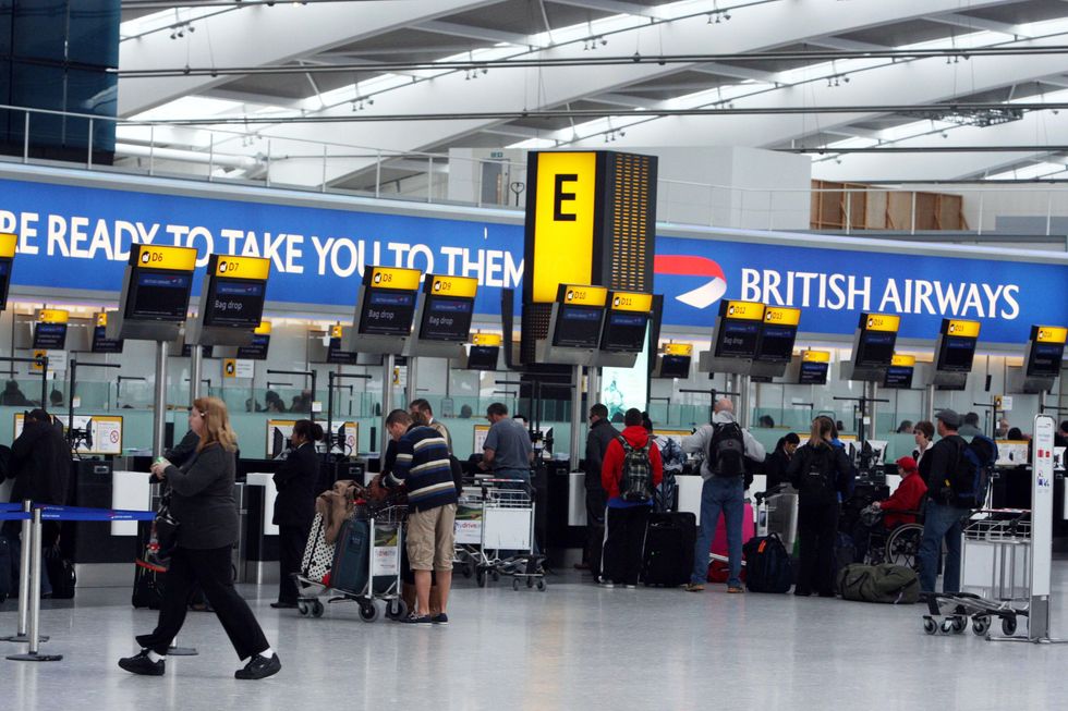 Passengers check in at Terminal 5 of Heathrow Airport in Middlesex, as British Airways cabin staff continue a third day of strike action