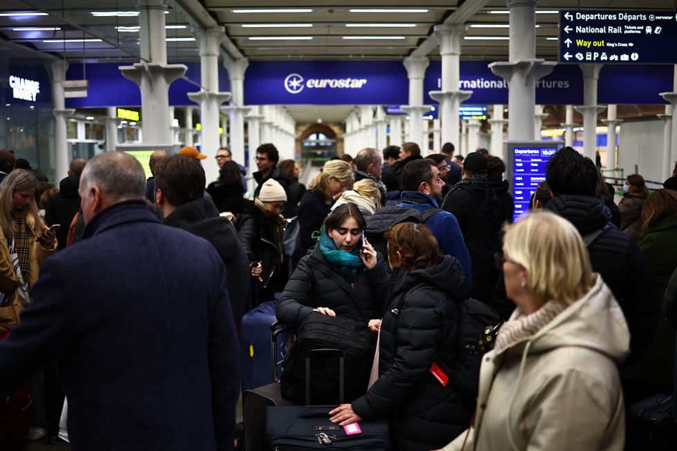 Passengers wait for news of Eurostar departures at St Pancras station in London