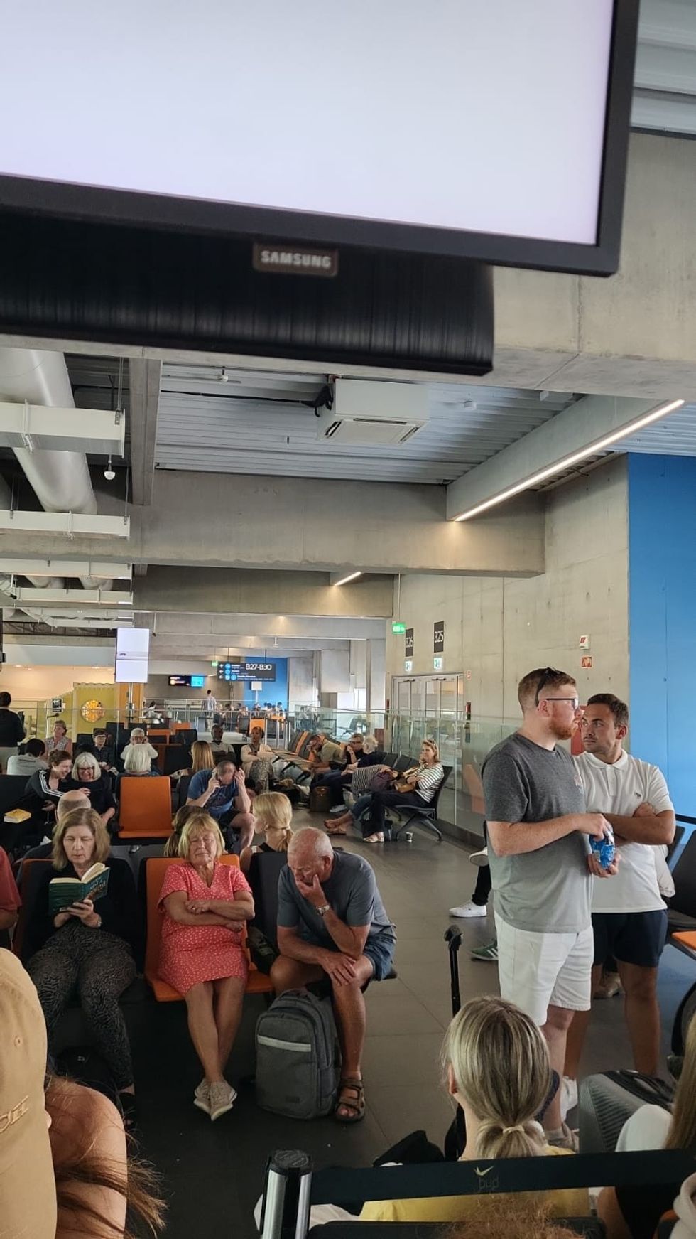 Passengers waiting at the gate at Budapest Airport.