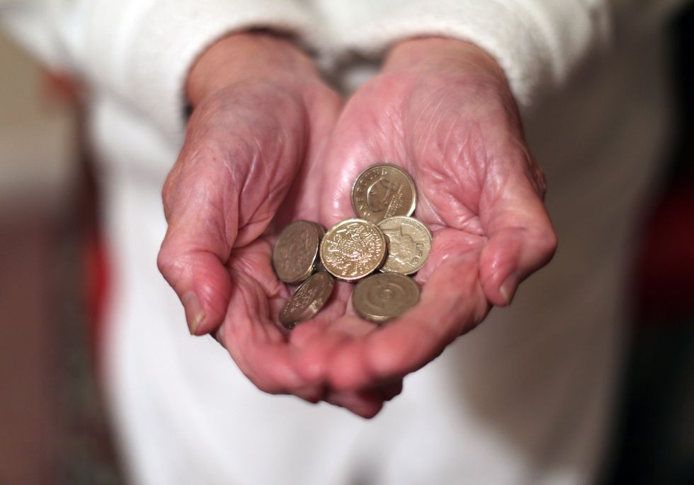 Pensioner holding coins