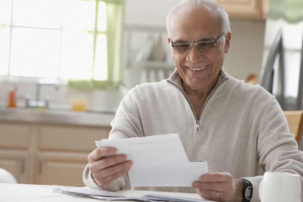 Pensioner looking at statement