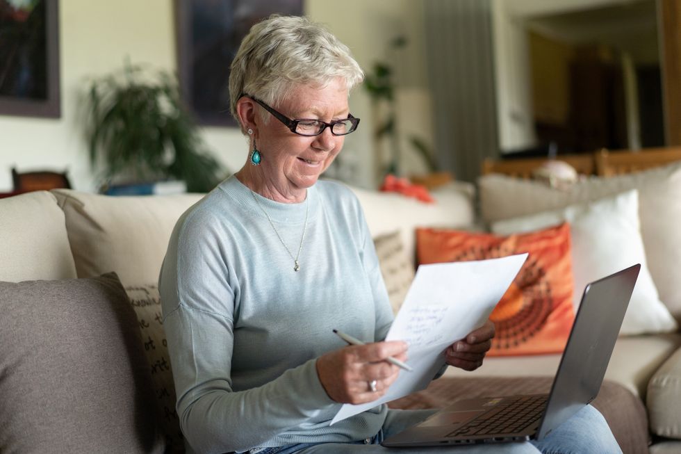 Pensioner looking happy while going over her finances