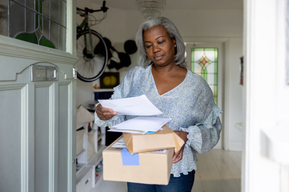 Pensioner looks at letter in post