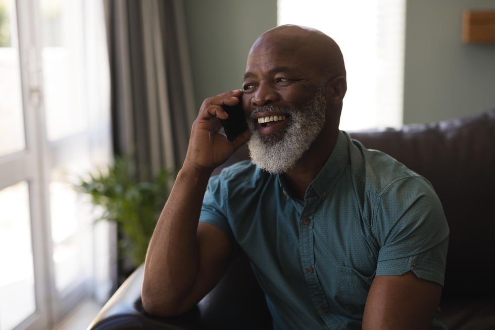 Pensioner on the phone while sitting on sofa