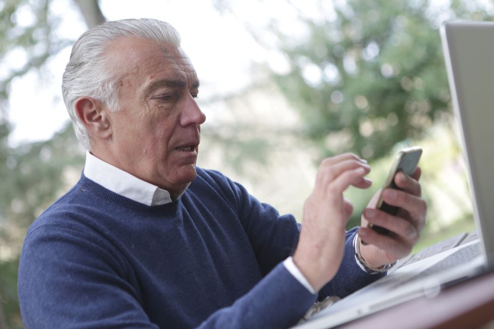 Pensioner uses mobile phone