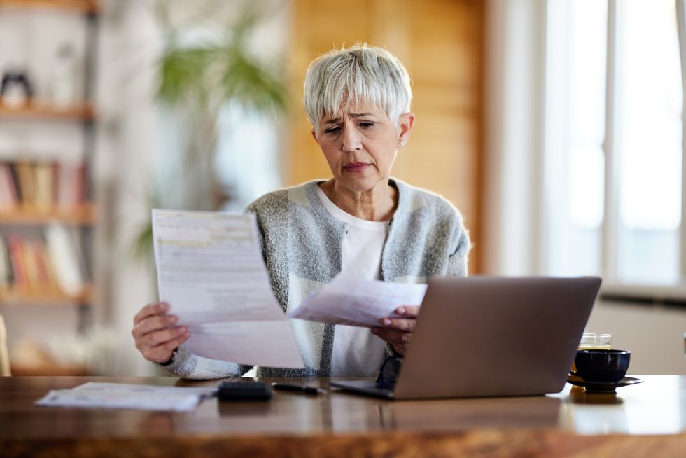 Pensioner worried at laptop