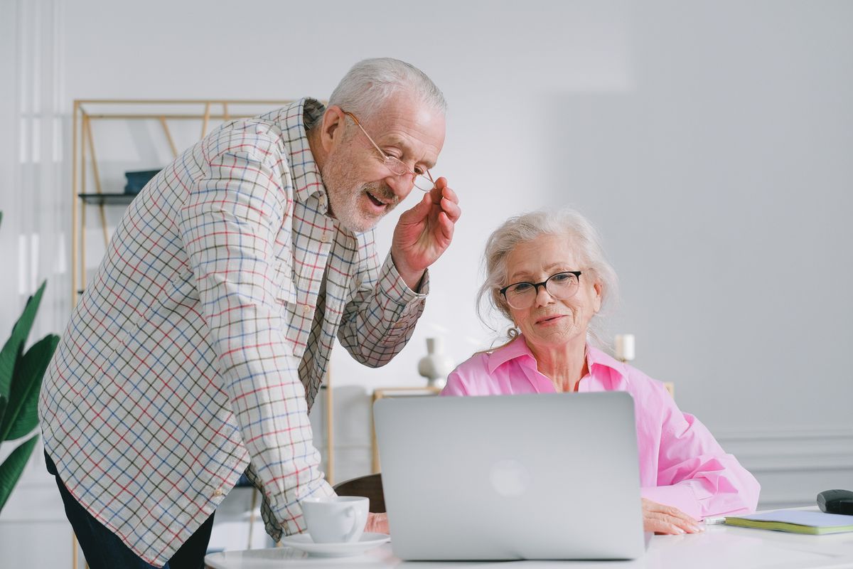 Pensioners looking at laptop