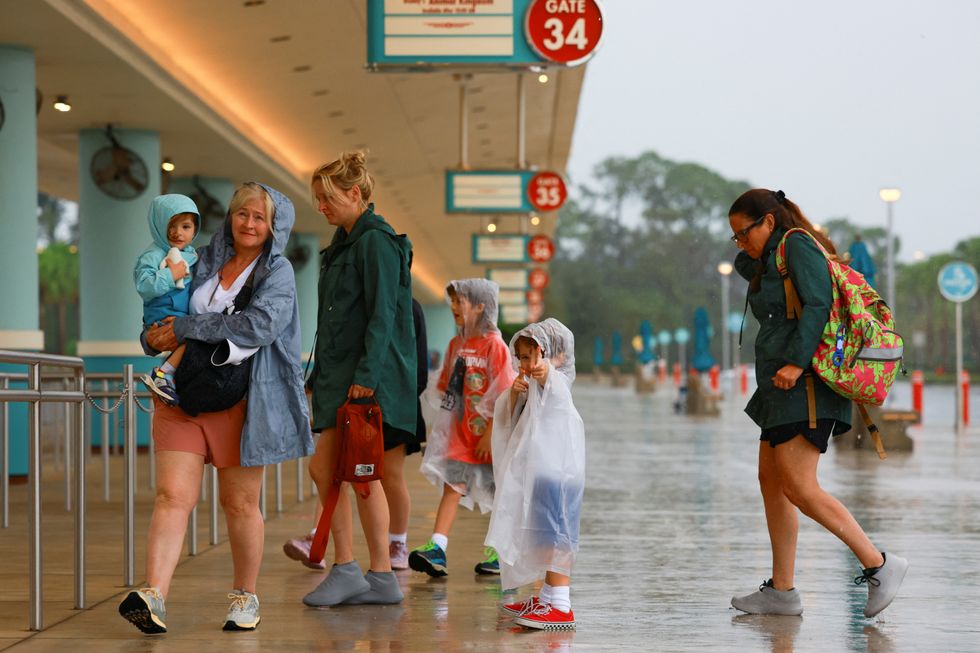 People arrive at Walt Disney World as Hurricane Milton approaches, in Orlando, Florida