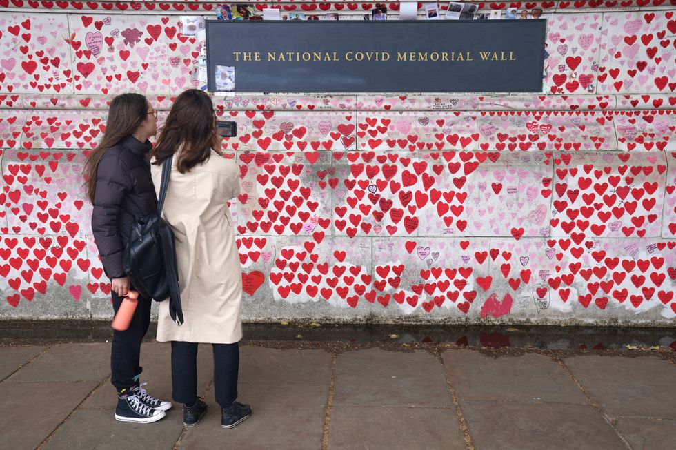 People at the National Covid Memorial Wall, central London, following the publication of Sue Gray's report into Downing Street parties in Whitehall during the coronavirus lockdown