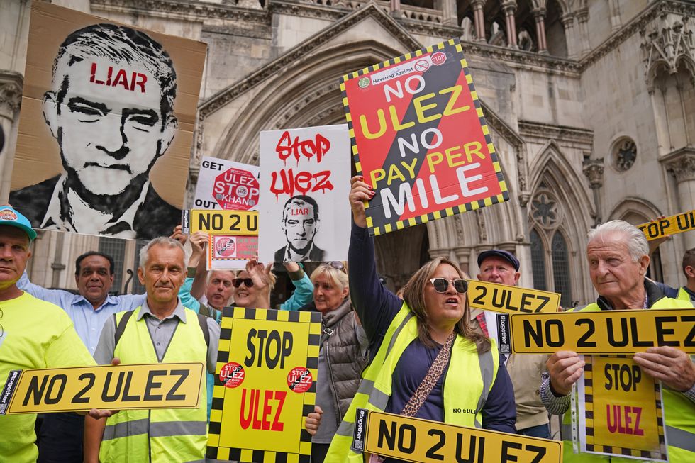 People demonstrate outside the High Court, central London, where five Conservative-led councils are challenging Mayor of London Sadiq Khan's intention to expand London's ultra low emission zone (Ulez)