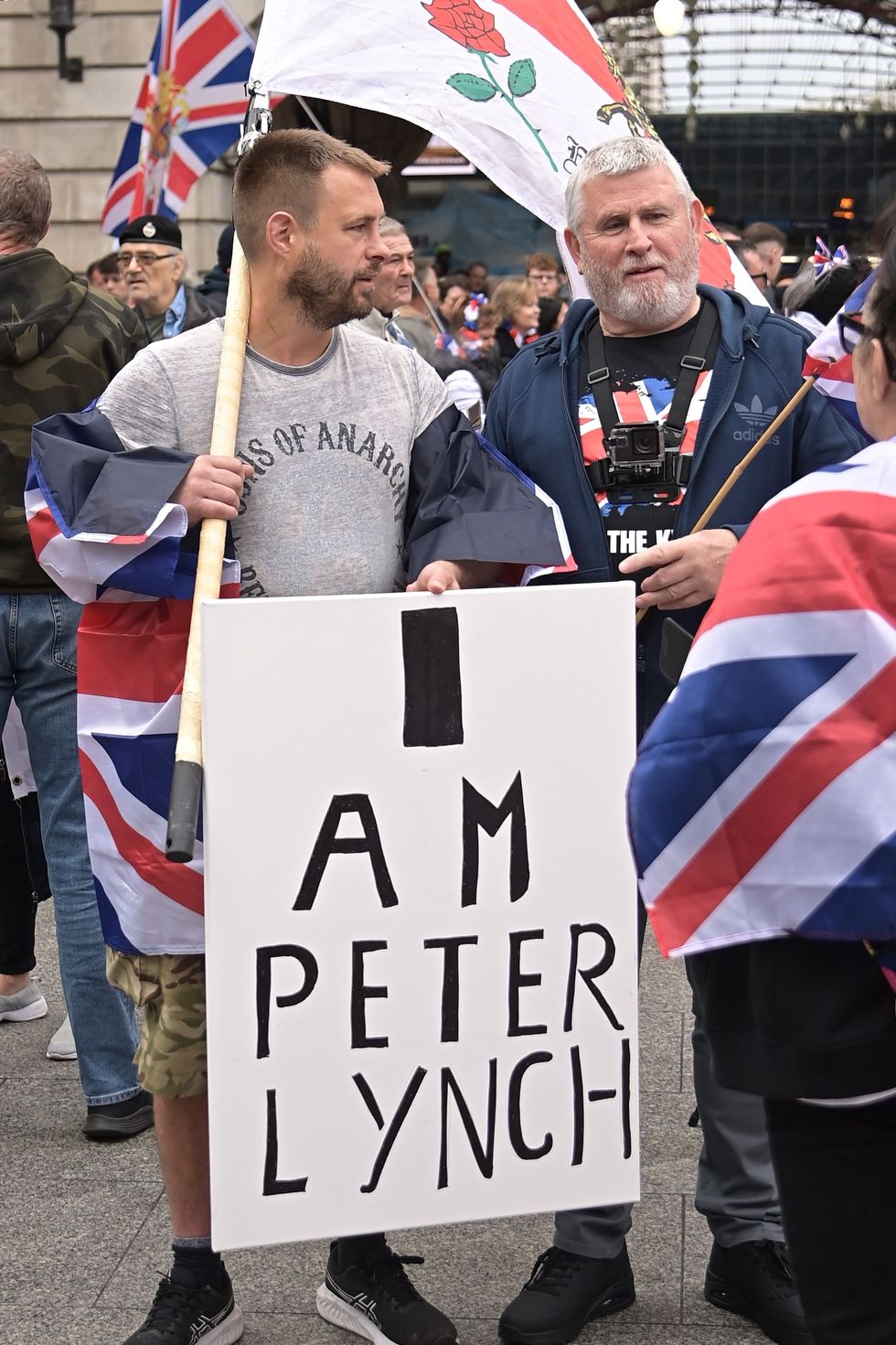 People gather at Victoria Station to stage a demonstration, organized by Tommy Robinson