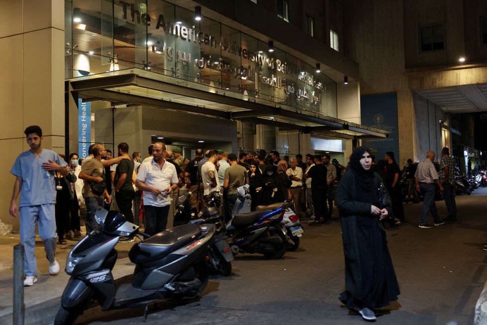 People gather outside American University of Beirut Medical Center (AUBMC) in Beirut, after hand-held radios used by Hezbollah detonated on Wednesday