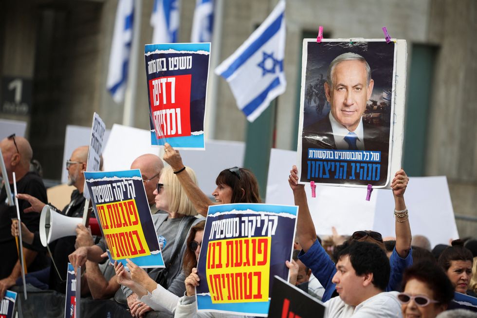 People in support of Israel's Prime Minister Benjamin Netanyahu react outside the court where he is due to take the stand for the first time in his long-running corruption trial