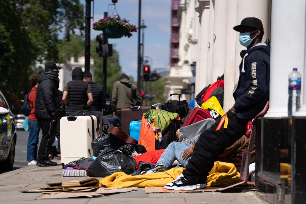 People milling around outside migrant hotel in London