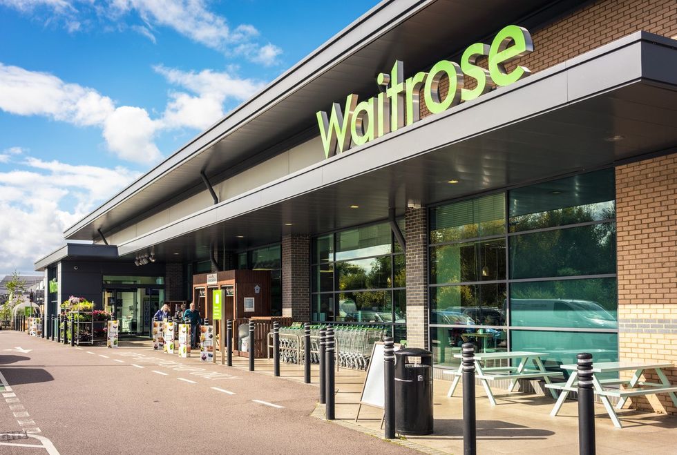 People outside the main entrance of a Waitrose supermarket in the English town of Bedford