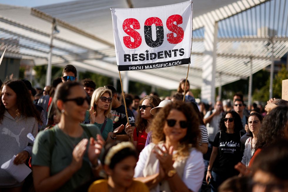 People take part in a protest against mass tourism and gentrification in the island ahead of summer season in Palma