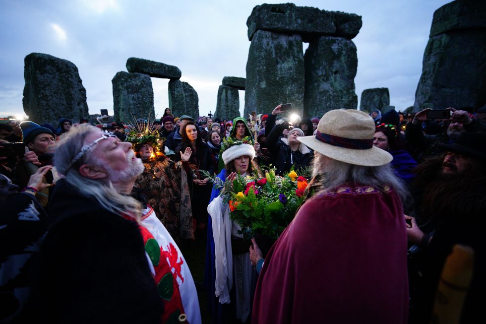 People take part in the winter solstice celebrations at the Stonehenge prehistoric monument on Salisbury Plain in Wiltshire.