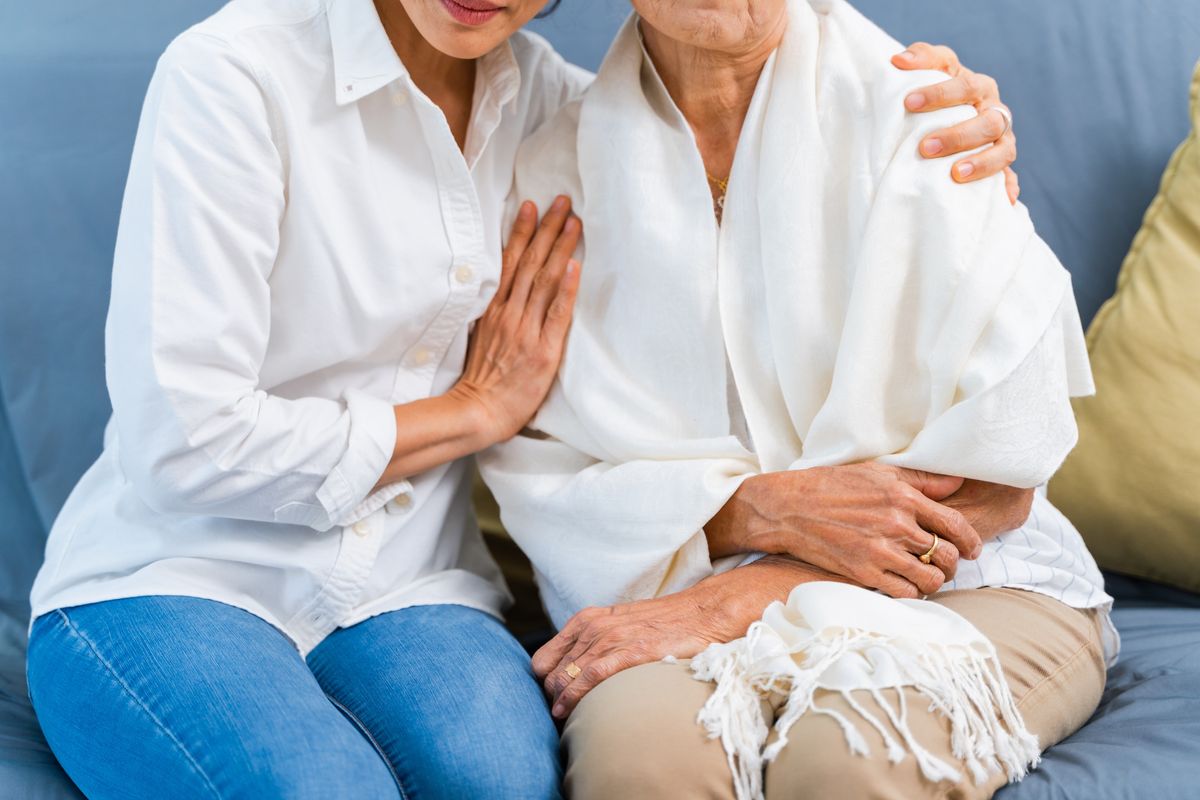 Person and elderly mother sitting together