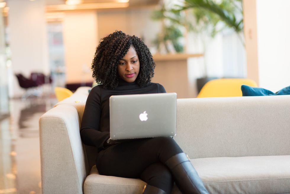 Person challenges council tax band on laptop while sitting on sofa