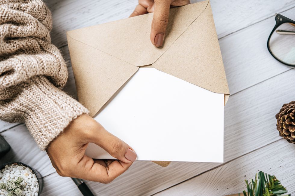 Person holds envelope