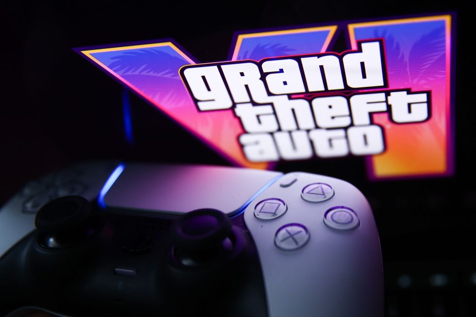 playstation 5 controller pictured next to the Grand Theft Auto logo