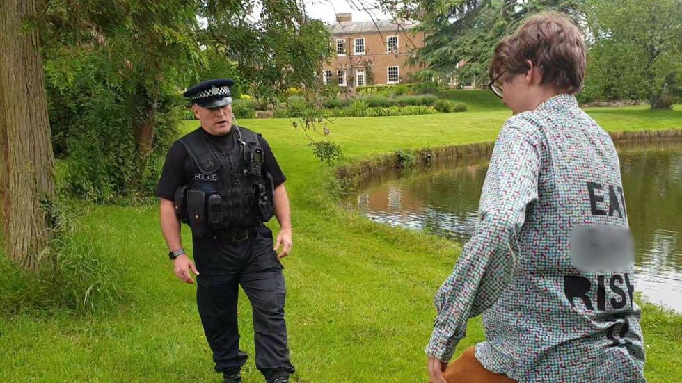 Police officer speaking to a protester