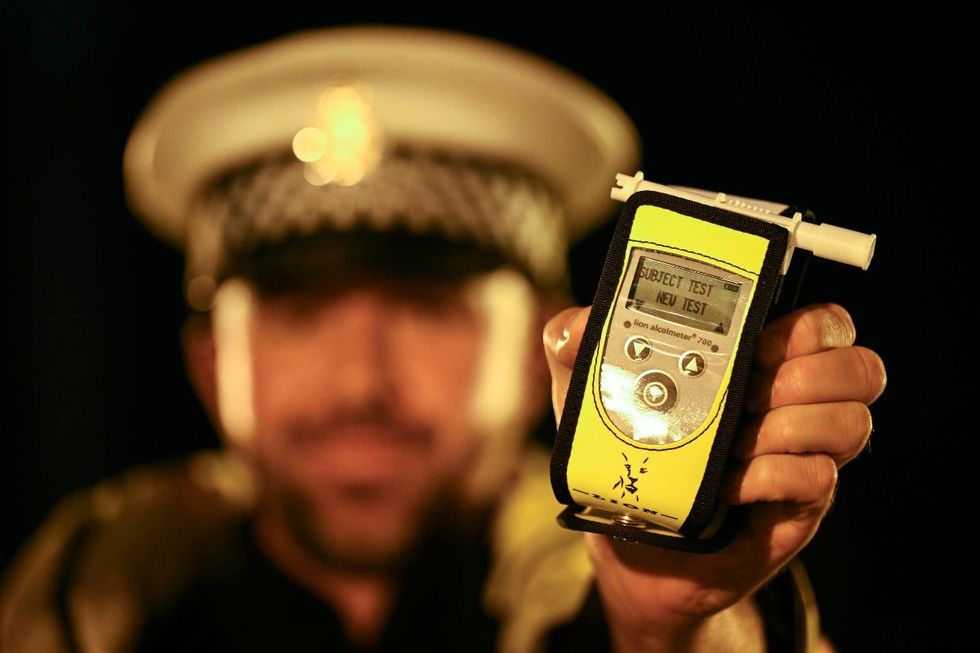 Police officer with a drug testing device