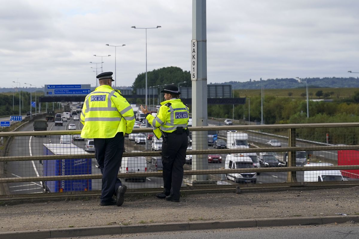 Police standing over a UK motorway