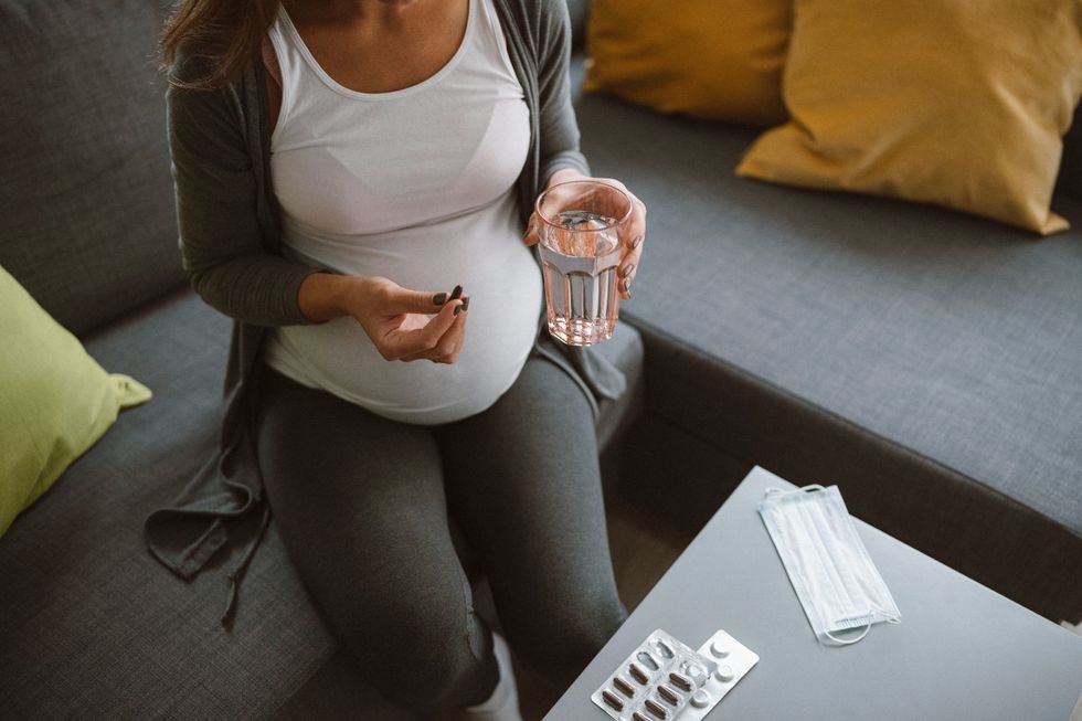 Pregnant woman taking pills