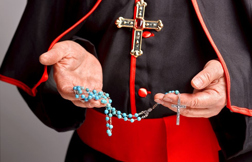 priest with rosary