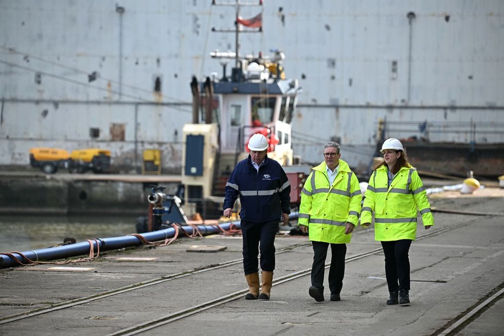 Prime Minister Sir Keir Starmer (centre) walks with Cammel Laird's chief executive officer David McGinley (left) and Labour MP for Birkenhead Alison McGovern (right) toward RFA Tidespring at Cammell Laird dock