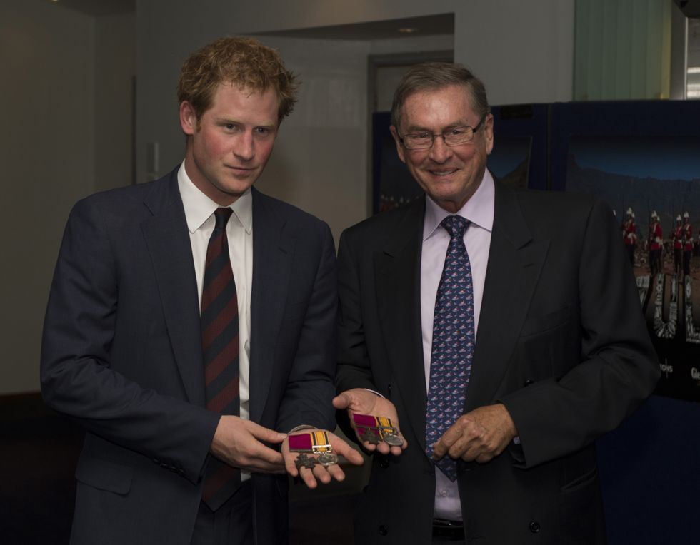 Prince Harry talks to Lord Ashcroft whilst being shown medals awarded for bravery\u200b