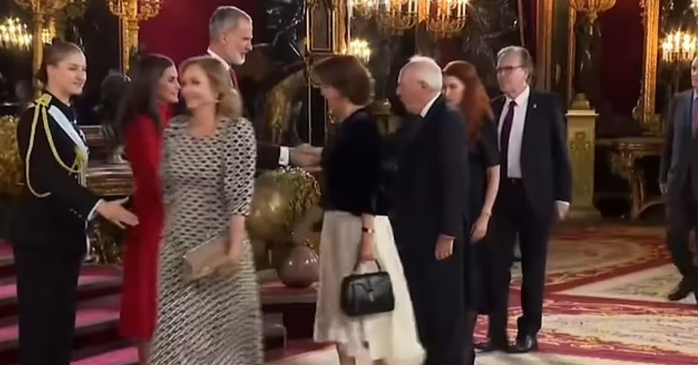 Princess Leonor reaching out to shake one women's hand.