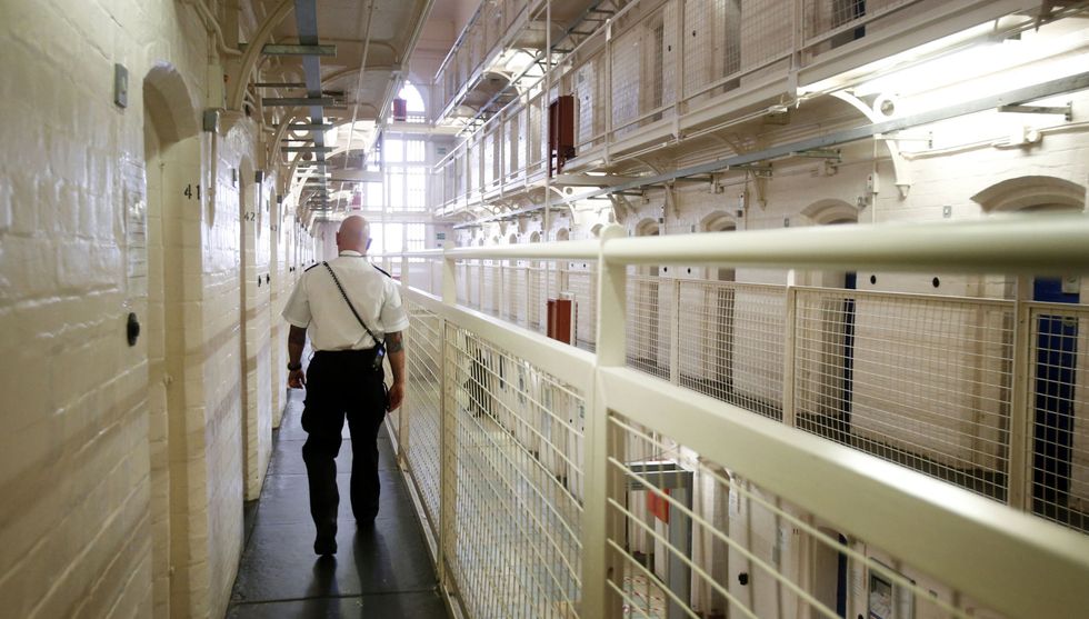 Prison guard walking through jail