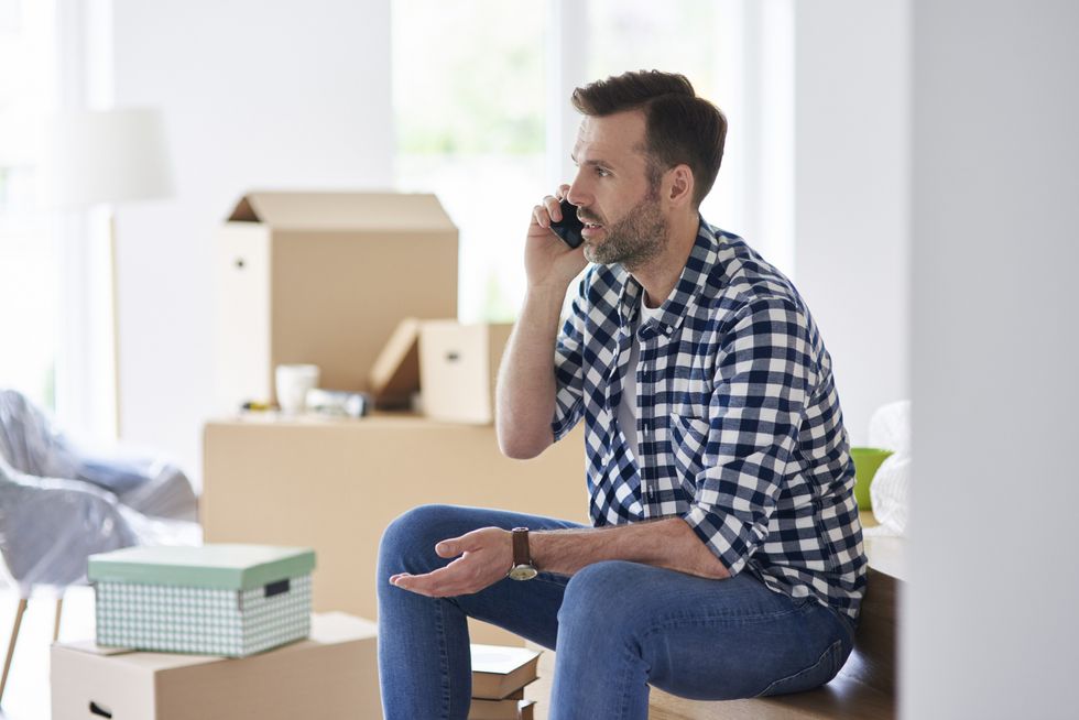 Property buyer looks worried on phone