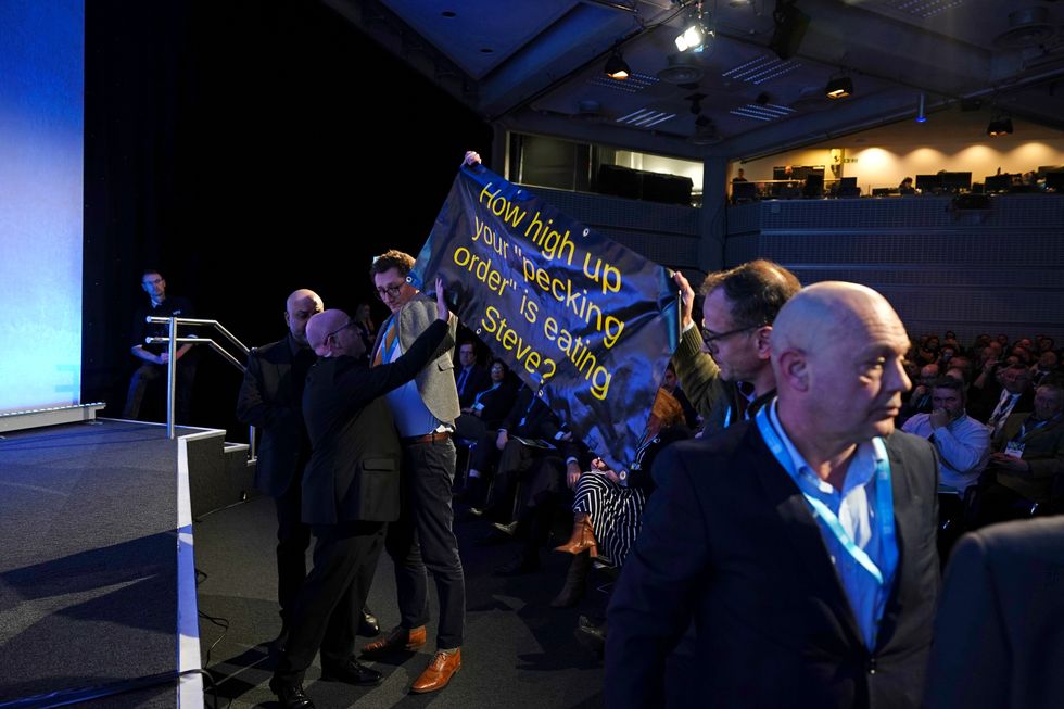 Protesters demonstrated inside the conference hall